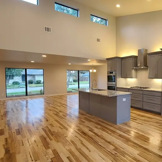 Open concept kitchen with newly painted white trim and light gray walls.